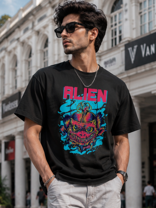 Male model wearing Zingleberry Alien Premium Black Cotton Graphic T-Shirt paired with white cargo trousers for a modern urban streetwear look.