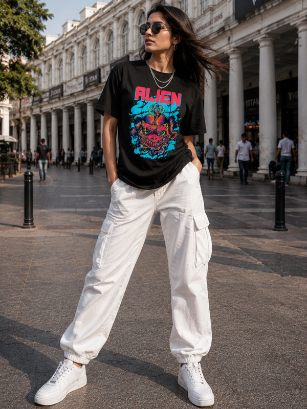 Female model wearing Zingleberry Alien Premium Unisex Black Cotton Graphic T-Shirt styled with white cargo pants for trendy summer streetwear fashion.