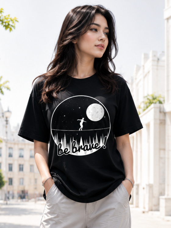 Female model wearing Zingleberry Be Brave Premium Unisex Black Cotton Graphic T-Shirt styled with light cargo pants for a modern summer streetwear outfit.
