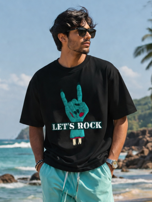 Male model wearing Zingleberry Let's Rock Premium Unisex Black Cotton Graphic T-Shirt with turquoise cargo pants for a stylish summer streetwear look.