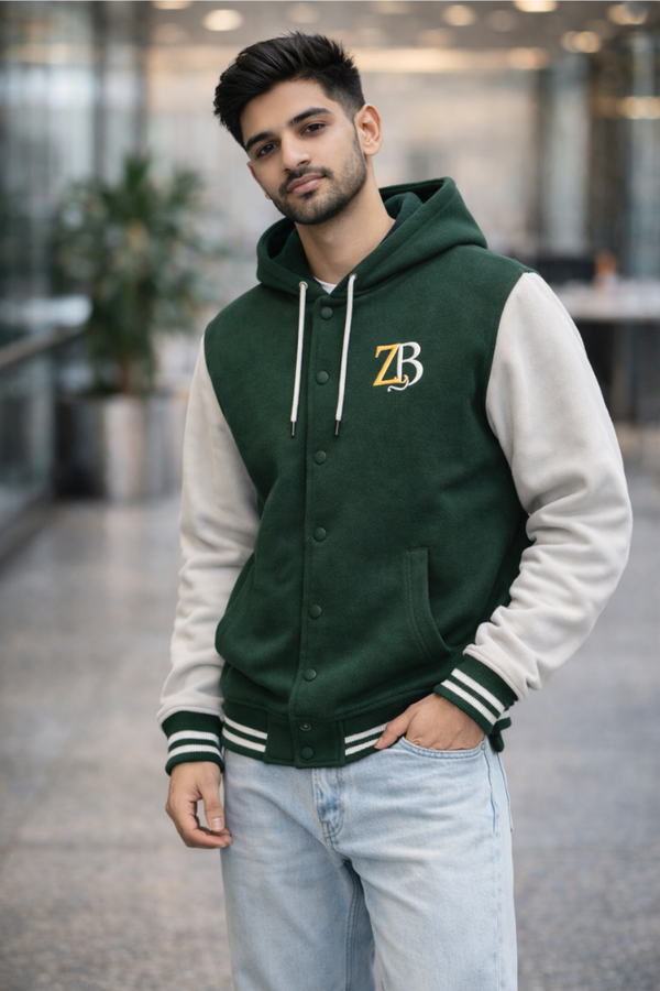 A man wearing the Zingleberry premium Bottle green and off-white unisex varsity jacket paired with light blue denim jeans.