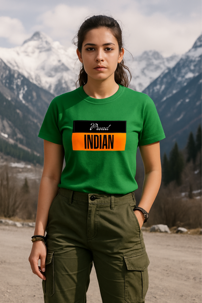 Female model in snow-capped mountains wearing Zingleberry green patriotic T-shirt with “Proud Indian” print, styled with olive green cargo pants