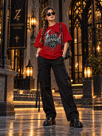 Female model wearing Zingleberry After Midnight Club red oversized Gothic T-shirt with black cargo trousers