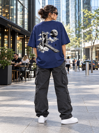 Female model wearing Zingleberry Another Dimension navy blue oversized T-shirt featuring surreal celestial back artwork