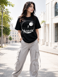 Female model wearing Zingleberry Be Brave Premium Unisex Black Cotton Graphic T-Shirt styled with light cargo pants for a modern summer streetwear outfit.