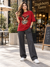 Woman wearing Zingleberry Beautiful Chaos premium red oversized T-shirt with Gothic butterfly and rose artwork.