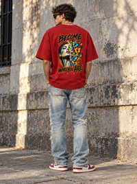 Man wearing Zingleberry Become Who You Are red unisex oversized T-shirt with large colourful butterfly portrait back graphic.