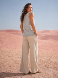 Zingleberry Cowgirl Energy grey women’s cotton tank top plain back view styled with beige wide-leg pants in desert setting