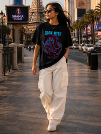 Female model wearing Zingleberry Dark Myth Premium Unisex Black Cotton Graphic T-Shirt styled with white cargo pants for casual summer street fashion
