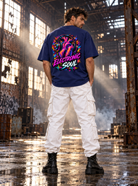 Male model showing Electronic Soul neon heart and headphones back artwork on Zingleberry navy blue oversized T-shirt with white cargo trousers