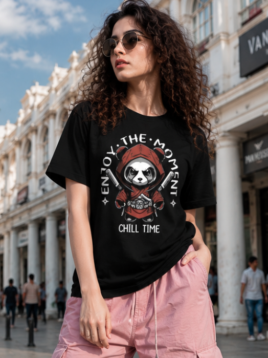 Female model wearing Zingleberry Enjoy The Moment Panda Premium Unisex Black Cotton Graphic T-Shirt styled with pink cargo pants for a trendy summer streetwear outfit.