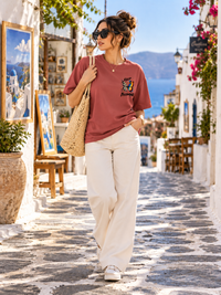 Woman wearing Zingleberry Keep Becoming premium oversized graphic T-shirt with off-white wide-leg trousers.