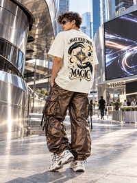 Male model wearing Zingleberry Make Your Own Magic premium oversized T-shirt with celestial graphic back print and cargo pants.