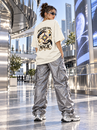 Female model wearing Zingleberry off-white oversized T-shirt featuring large Make Your Own Magic celestial back print.