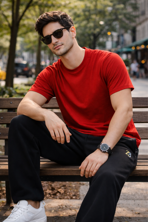 Male model wearing Zingleberry premium unisex black sweatpants with red t-shirt, featuring relaxed fit and cotton terry fabric.