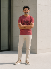Male model wearing Zingleberry Never Stop Learning red pure cotton graphic T-shirt with beige trousers and casual sneakers.