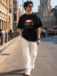 Male model wearing Zingleberry Premium Unisex Classic Crew Off-Road Sunset black graphic T-shirt with white trousers in a premium urban streetwear photoshoot.