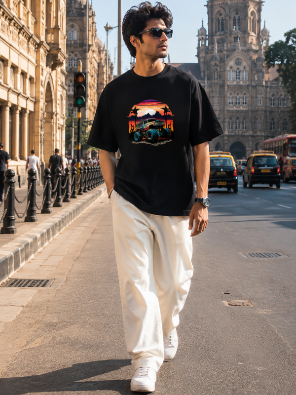 Male model wearing Zingleberry Premium Unisex Classic Crew Off-Road Sunset black graphic T-shirt with white trousers in a premium urban streetwear photoshoot.