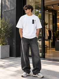 Male model wearing Zingleberry Same Sky Different World premium white unisex oversized T-shirt with front chest graphic.