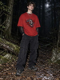 Male model wearing Zingleberry Serpent King red oversized 100% cotton graphic T-shirt with black cargo pants in dark forest setting.