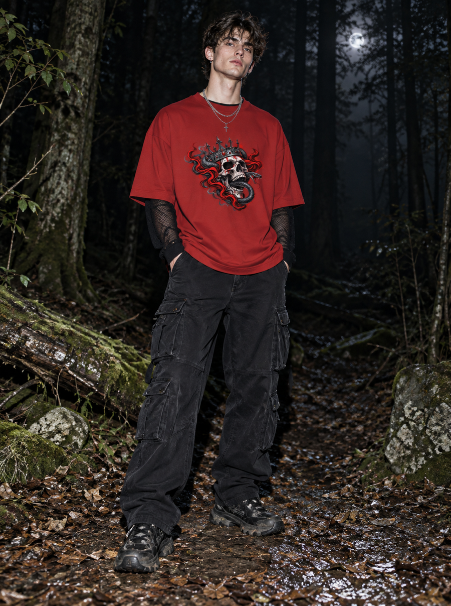 Male model wearing Zingleberry Serpent King red oversized 100% cotton graphic T-shirt with black cargo pants in dark forest setting.