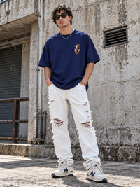 Male model wearing Zingleberry Slow Down premium navy blue unisex oversized T-shirt with cosmic front chest print.