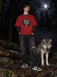 Male model wearing Zingleberry Stay Wild red oversized 100% cotton graphic T-shirt with black distressed jeans.
