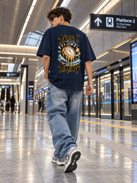 Man wearing Zingleberry Trust Your Timing unisex oversized T-shirt with large celestial clock and moon phase back print.