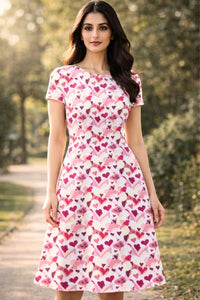 Zingleberry Vastra pink, fuchsia, and white heart print midi dress with short sleeves and round neck.