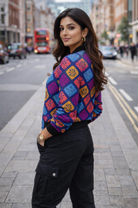 Back view of women’s premium all over print bomber jacket featuring bold multicolor geometric design and ribbed cuffs