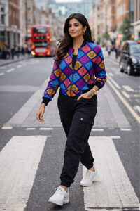 Women wearing premium AOP bomber jacket with vibrant geometric print, casual streetwear look with cargo pants