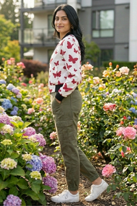 Side view of Zingleberry Premium Women’s bomber jacket featuring red butterfly print on white base, modern winter jacket